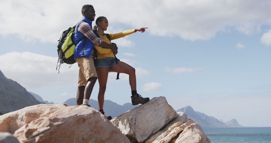 Couple Embracing and Exploring Mountain Trails on Adventure Hike