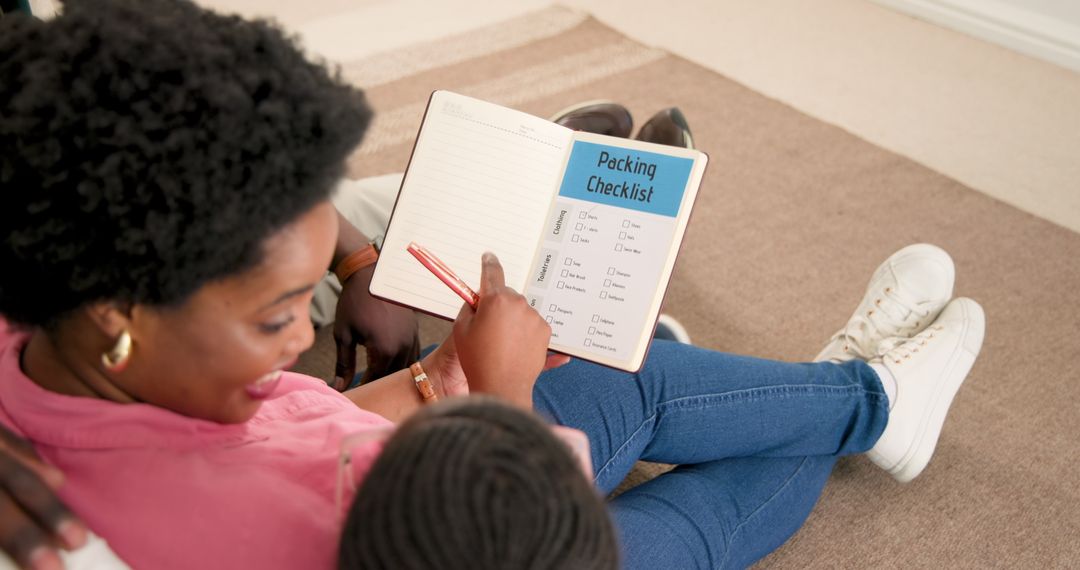 Mother and Daughter Planning Checklist Together on Couch