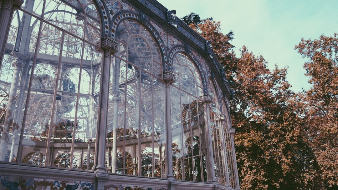 Vintage Glasshouse with Intricate Architecture and Autumn Foliage - Free Images, Stock Photos and Pictures on Pikwizard.com