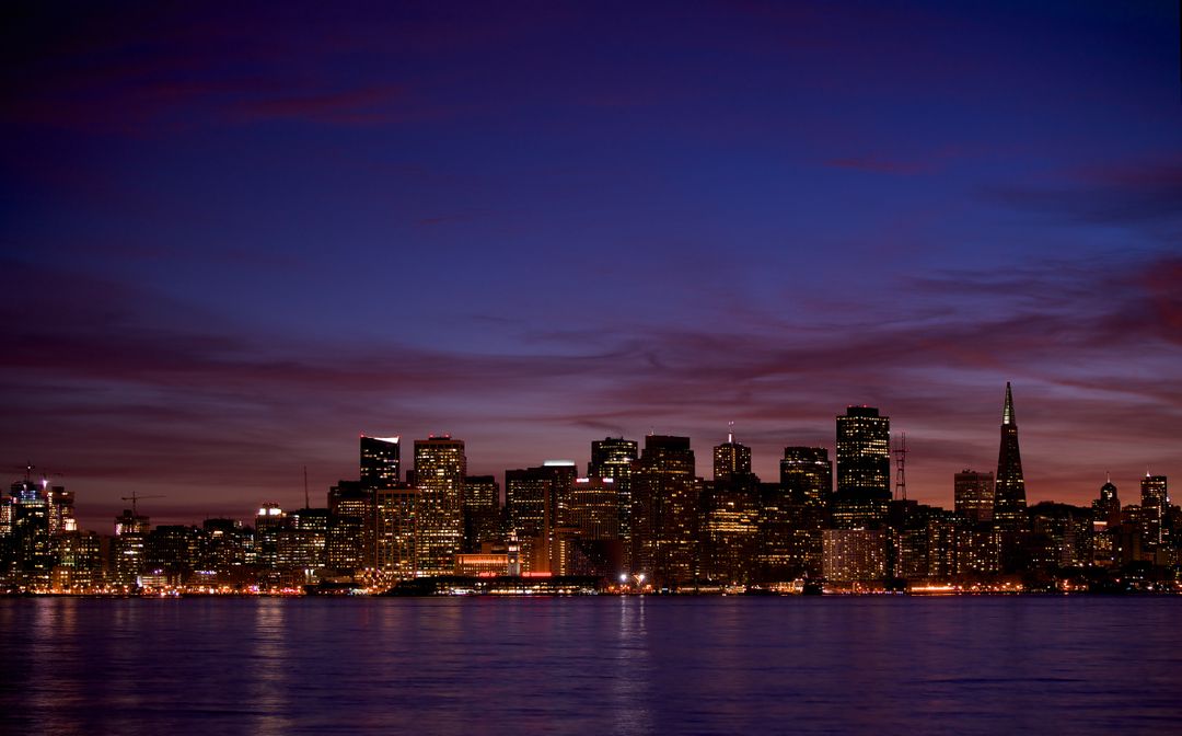 San Francisco Skyline at Twilight, Illuminated City Lights Reflecting on Water - Free Images, Stock Photos and Pictures on Pikwizard.com