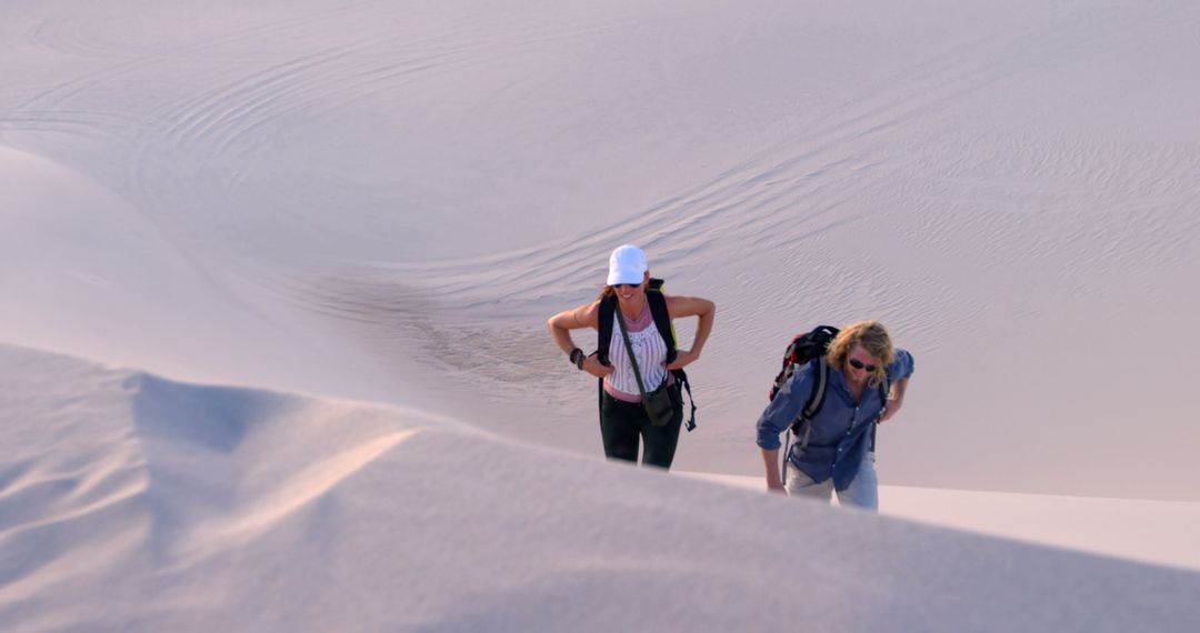 Two Women Hiking in Sand Dunes at Sunset - Free Images, Stock Photos and Pictures on Pikwizard.com