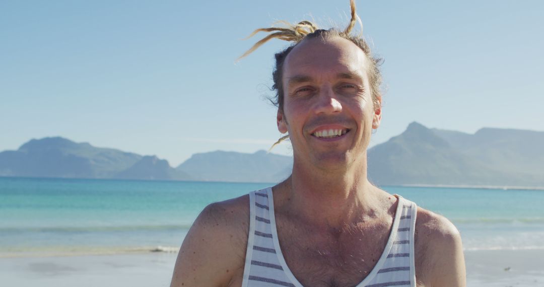 Smiling Man with Dreadlocks Enjoying Beach Vacation - Free Images, Stock Photos and Pictures on Pikwizard.com