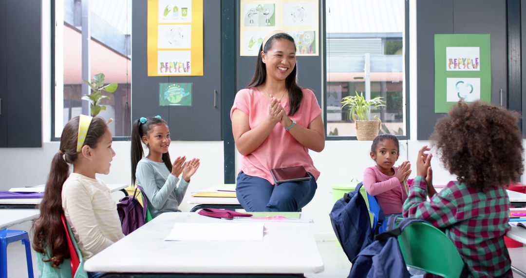 Teacher Engaging with Students in Classroom Activity in School Setting