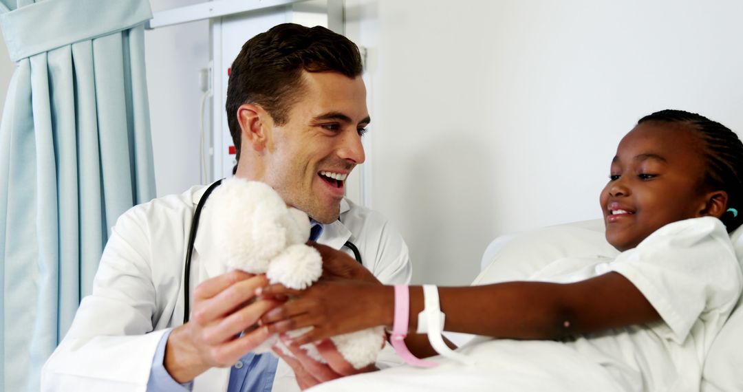 Doctor Comforting Child Patient in Hospital Room with a Toy - Free Images, Stock Photos and Pictures on Pikwizard.com