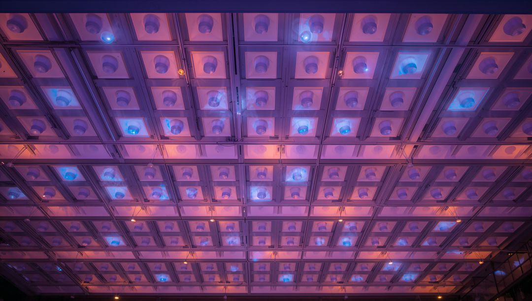 Glowing Modular Ceiling Grid Featuring Illuminated Square Panels and Blue LED Domes