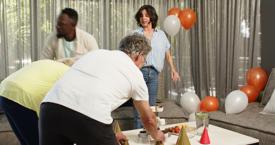 Colleagues Setting Up Party in Office Lounge with Balloons and Treats