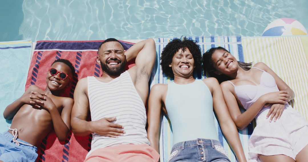 Happy Family Sunbathing by Pool on Summer Day