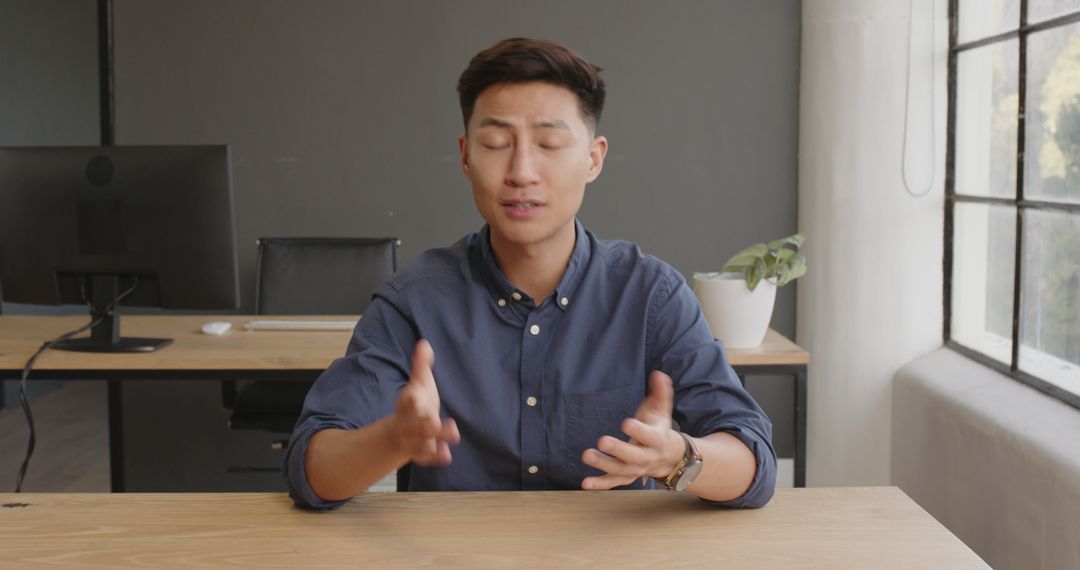 Businessman Expressively Presenting Ideas in Modern Office