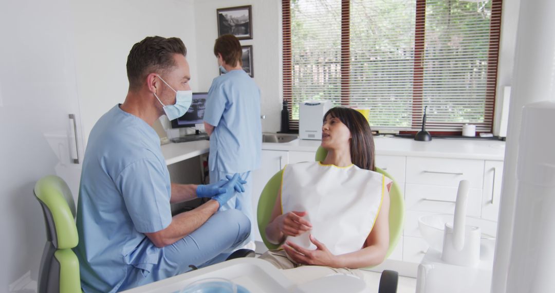 Dentist and Patient Discussing Treatment in Dental Office - Free Images, Stock Photos and Pictures on Pikwizard.com