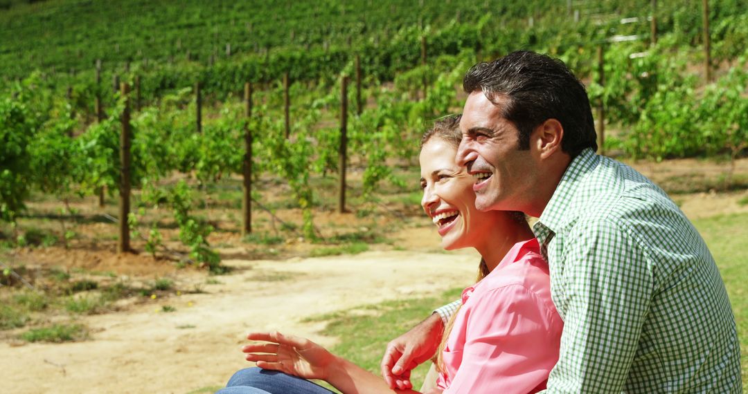 Happy Couple Relaxing at Vineyard in Sunlight