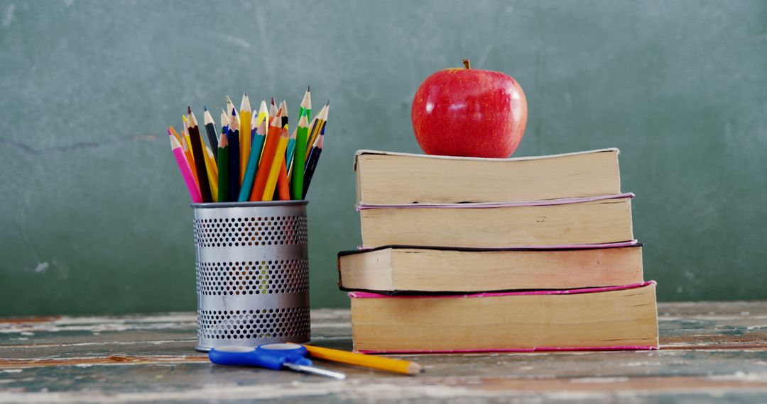 Classroom Symbolism With Books, Colorful Pencils, and Apple