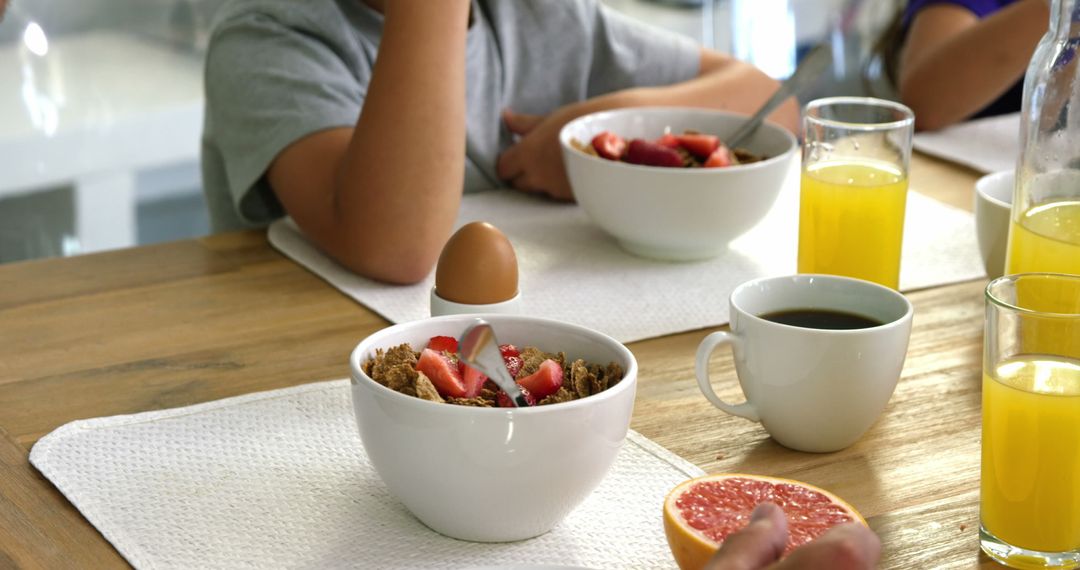 Family Breakfast Table with Cereal, Juice, and Coffee - Free Images, Stock Photos and Pictures on Pikwizard.com