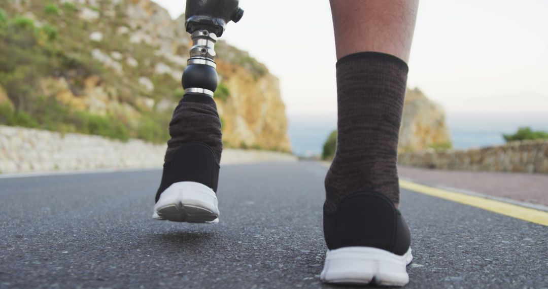 Close-up of amputee wearing prosthetic leg and running shoes on road - Free Images, Stock Photos and Pictures on Pikwizard.com