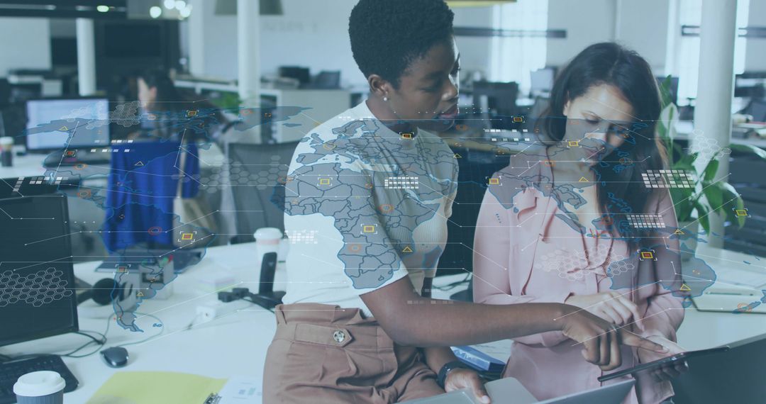 Collaborating on global data dashboard with world-map overlay using laptop in open office