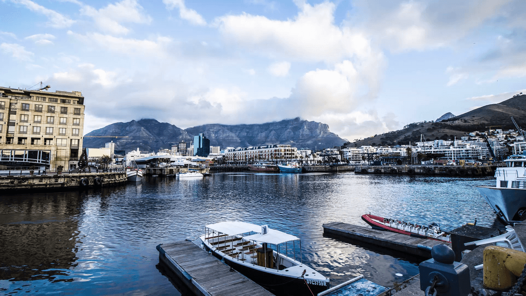 Picturesque Waterfront Cityscape with Mountains on Transparent Background