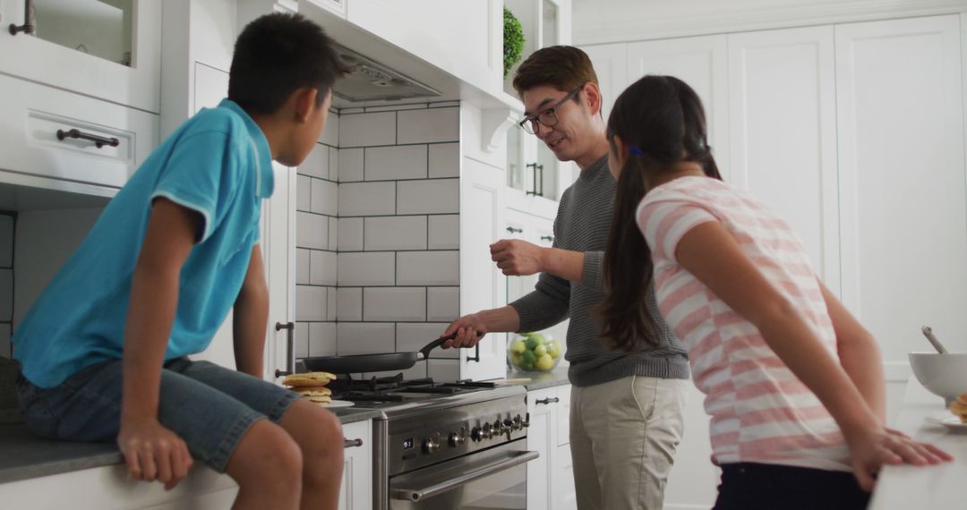 Father Cooking Breakfast with Kids in Modern Kitchen - Free Images, Stock Photos and Pictures on Pikwizard.com