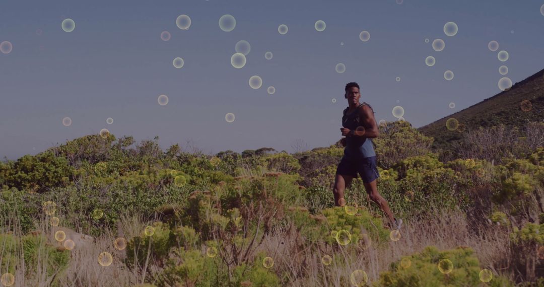 Athletic Man Running on Sunny Hill Trail for Motivation and Fitness
