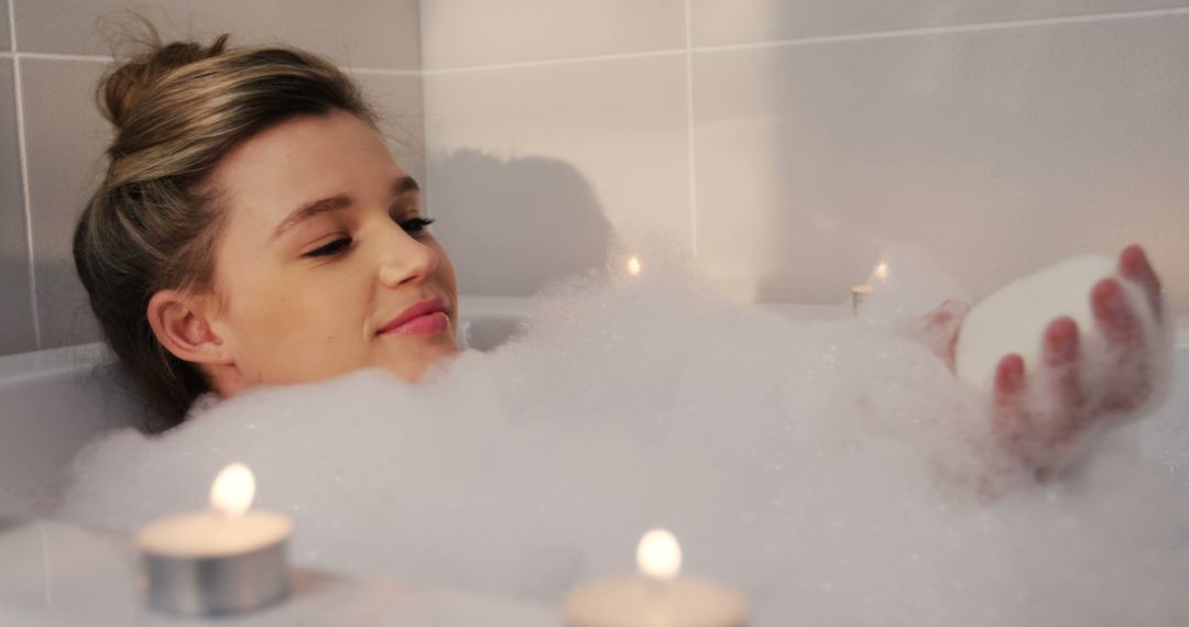 Relaxing Woman Enjoying Bubble Bath with Candles - Free Images, Stock Photos and Pictures on Pikwizard.com