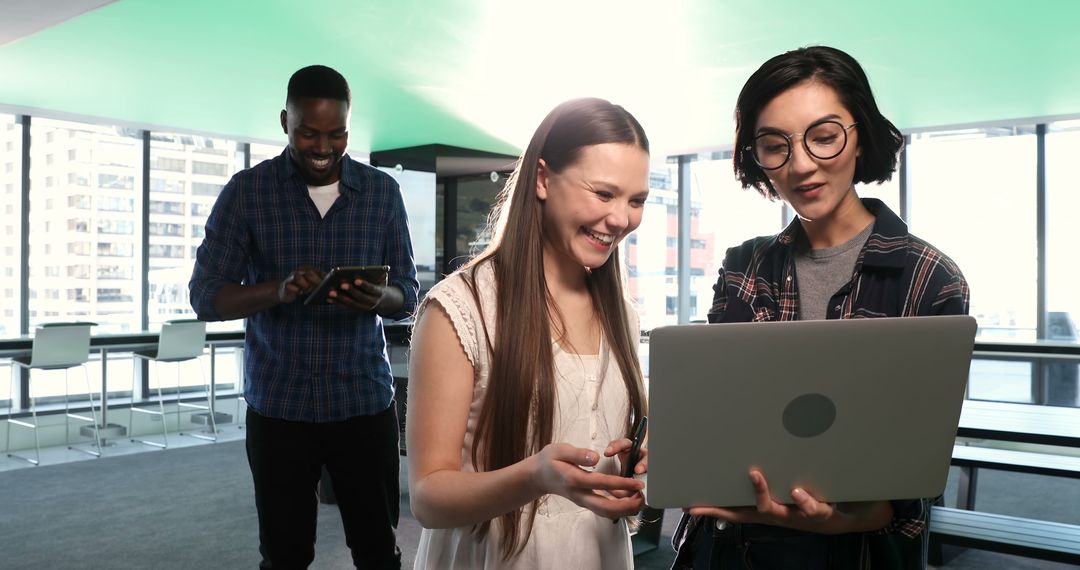 Diverse Team Collaborating with Technology in Modern Office Space