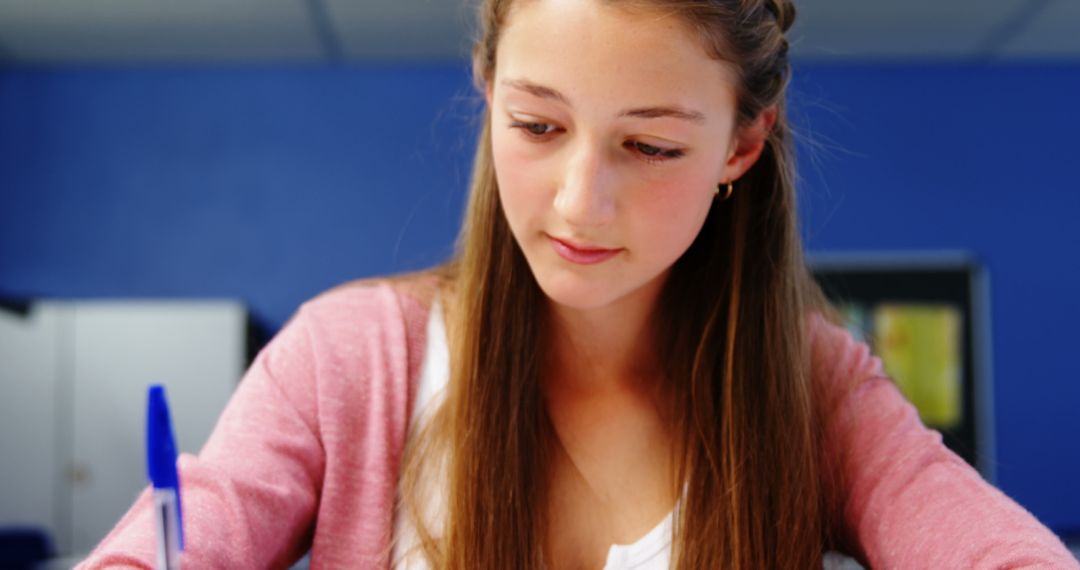 Focused Student Studying in Classroom with Pen and Notebook - Free Images, Stock Photos and Pictures on Pikwizard.com