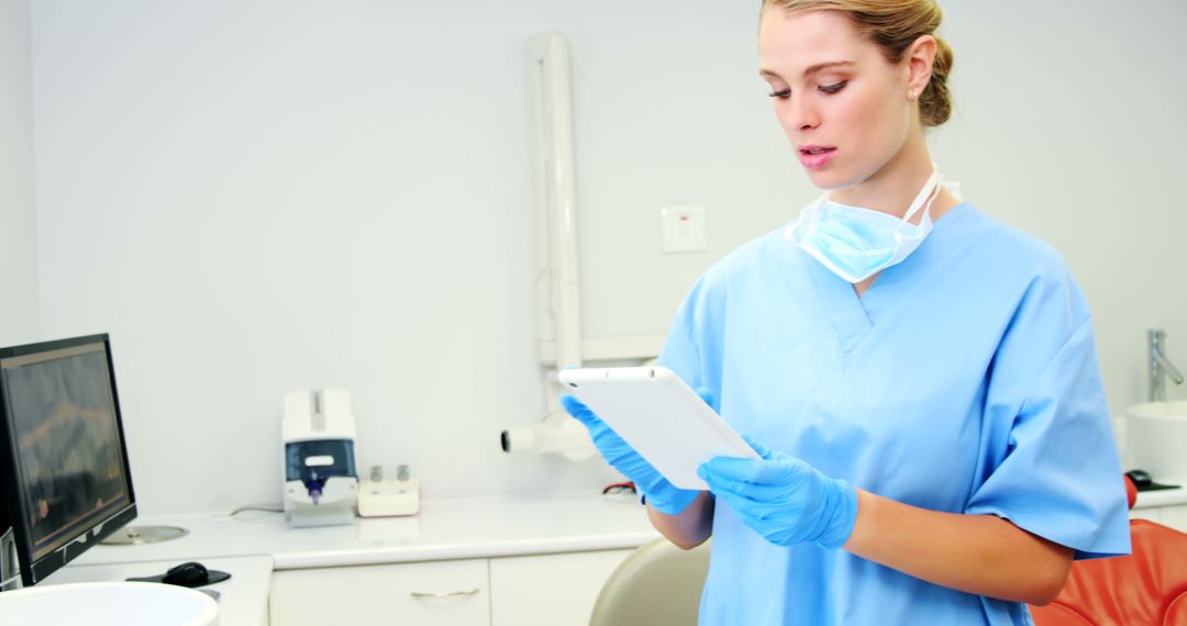 Female healthcare worker wearing gloves using digital tablet in clinic - Free Images, Stock Photos and Pictures on Pikwizard.com