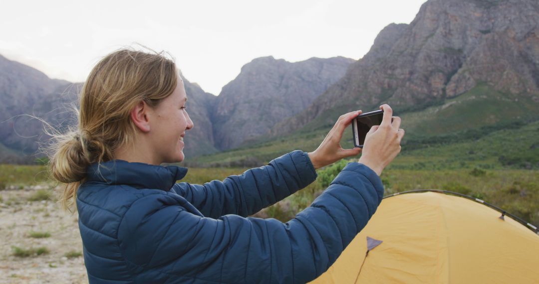 Woman Capturing Mountain Landscape during Camping Trip - Free Images, Stock Photos and Pictures on Pikwizard.com