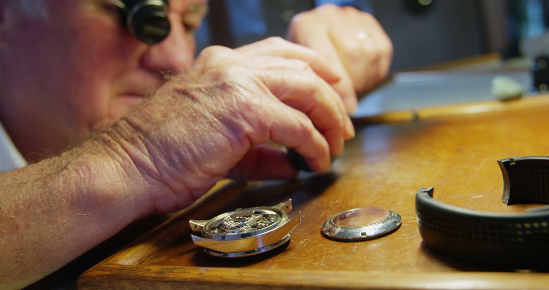 Elderly Watchmaker Repairing wristwatch at Workbench - Free Images, Stock Photos and Pictures on Pikwizard.com