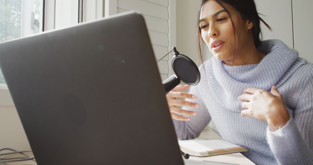 Image of biracial woman taking part in online interview on laptop at home - Free Images, Stock Photos and Pictures on Pikwizard.com