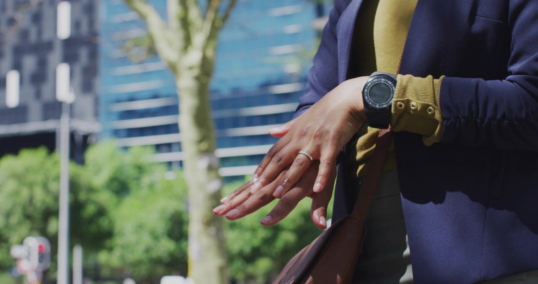 Hands Displaying Rings and Watch in Urban Environment