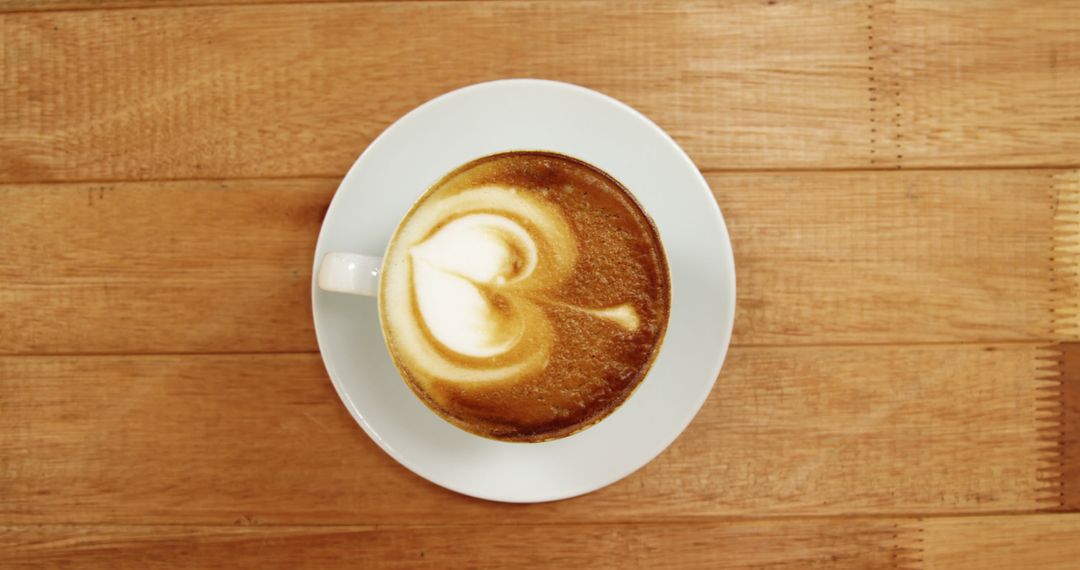 Top View of Cappuccino with Heart Latte Art on Wooden Table - Free Images, Stock Photos and Pictures on Pikwizard.com