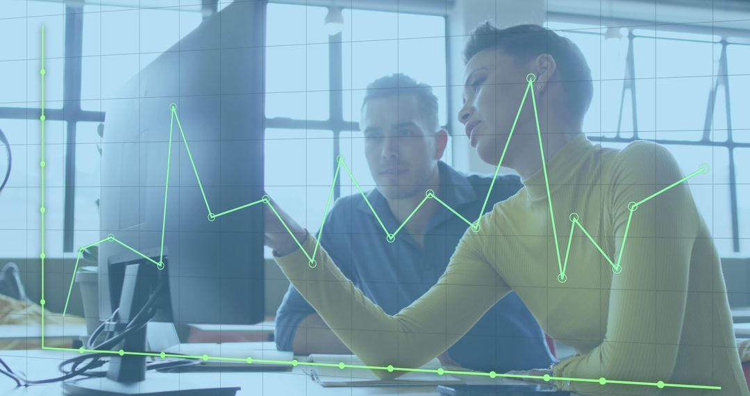 Colleagues Analyzing Financial Data on Computer Monitor