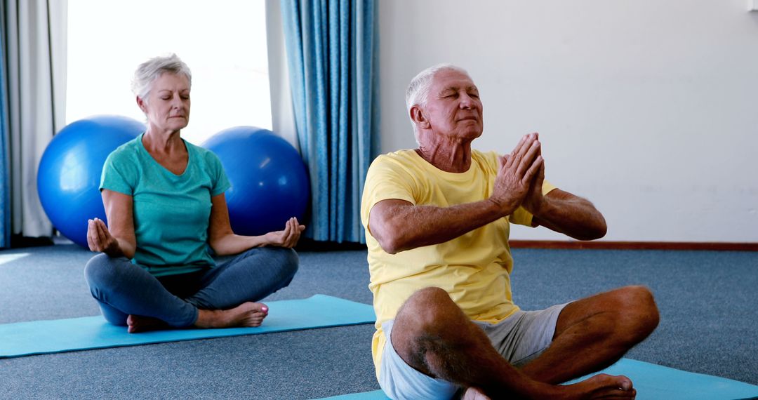 Seniors Practicing Meditation in Fitness Studio - Free Images, Stock Photos and Pictures on Pikwizard.com