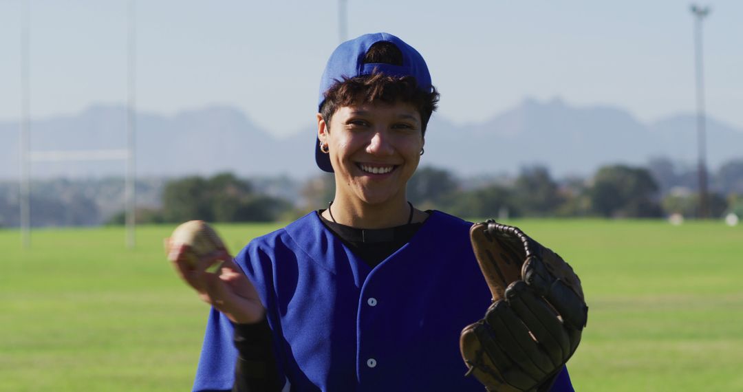 Happy Female Baseball Player in Blue Uniform Holding Glove and Ball Outdoors - Free Images, Stock Photos and Pictures on Pikwizard.com