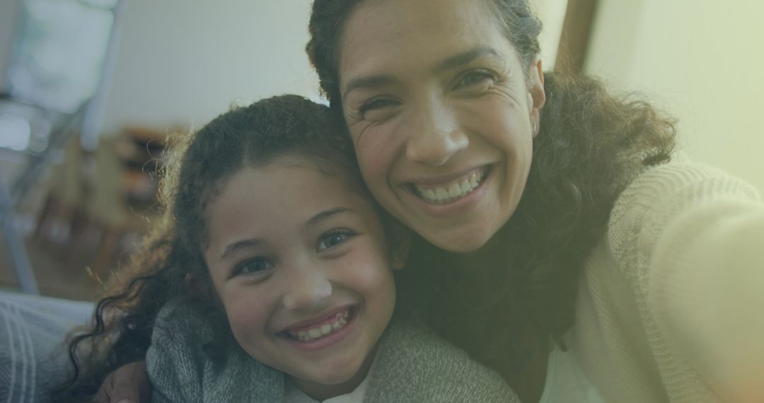 Smiling Mother and Daughter Embracing at Home