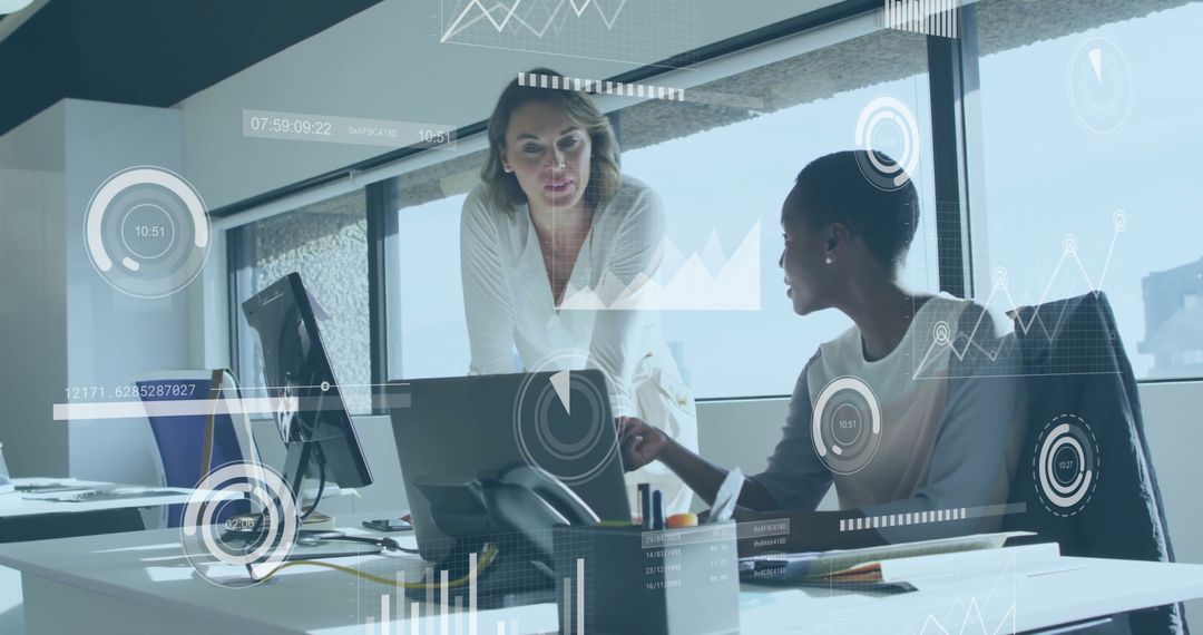 Women Collaborating Over Data Insights in Modern Office Environment