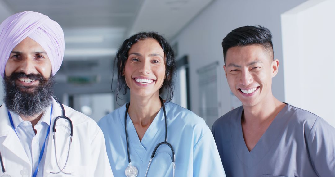 Diverse medical team smiling in hospital hallway showing unity and collaboration - Free Images, Stock Photos and Pictures on Pikwizard.com