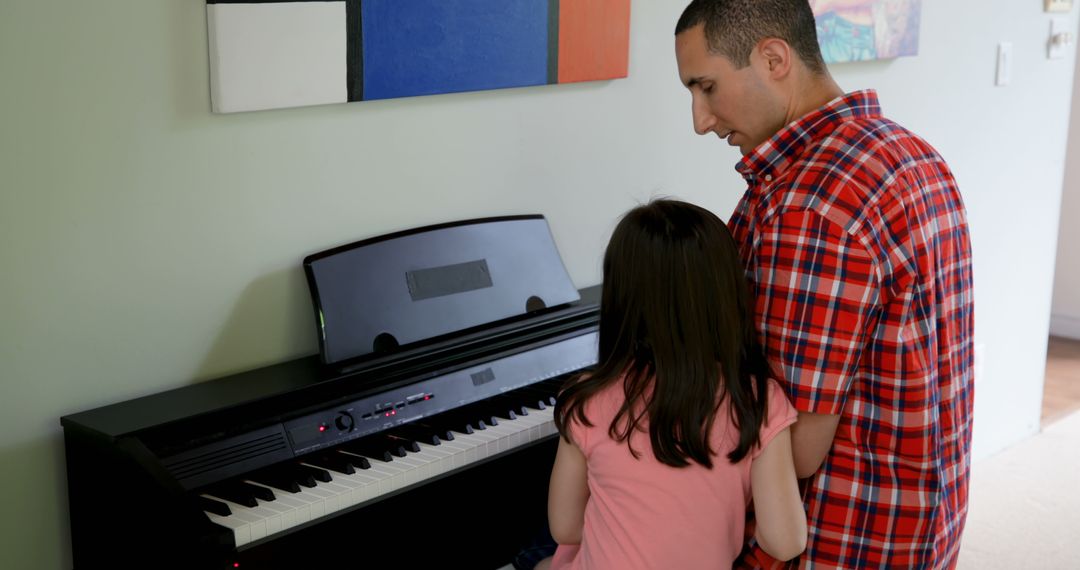 Father and Daughter Learning Piano Together - Free Images, Stock Photos and Pictures on Pikwizard.com