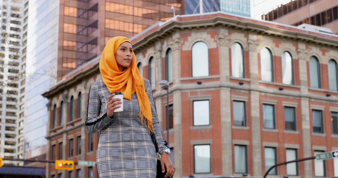 Confident Woman Walking with Coffee Amid Urban Scenery - Free Images, Stock Photos and Pictures on Pikwizard.com