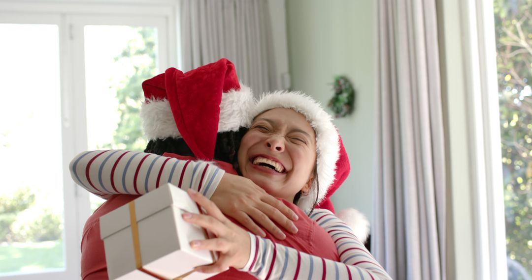 Happy Couple Hugging and Exchanging Gift in Christmas Celebration - Free Images, Stock Photos and Pictures on Pikwizard.com