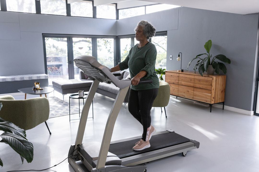 Senior African American Woman Walking on Treadmill at Home
