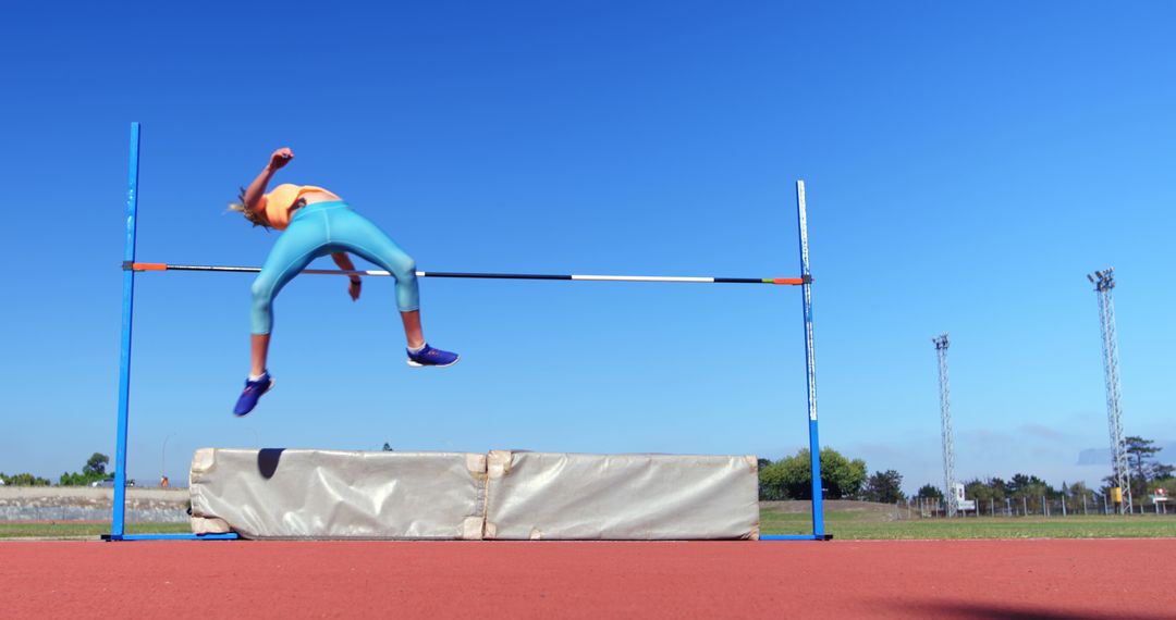 Female Athlete High Jumping Over Bar on Outdoor Track - Free Images, Stock Photos and Pictures on Pikwizard.com