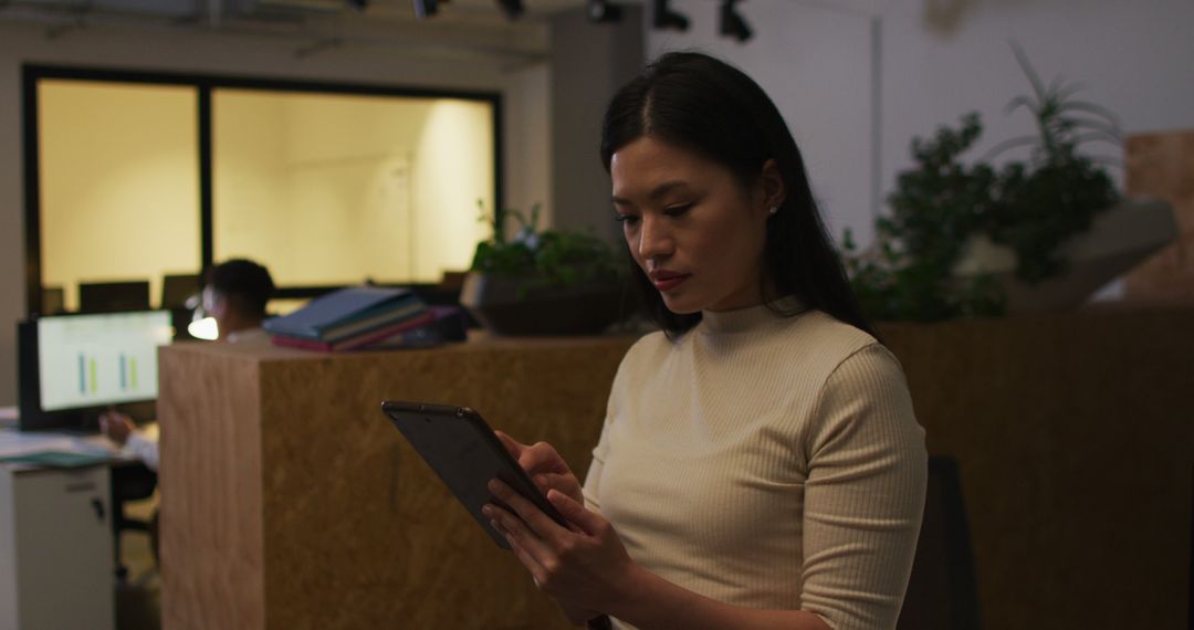 Image of asian businesswoman using tablet, working late in office - Free Images, Stock Photos and Pictures on Pikwizard.com