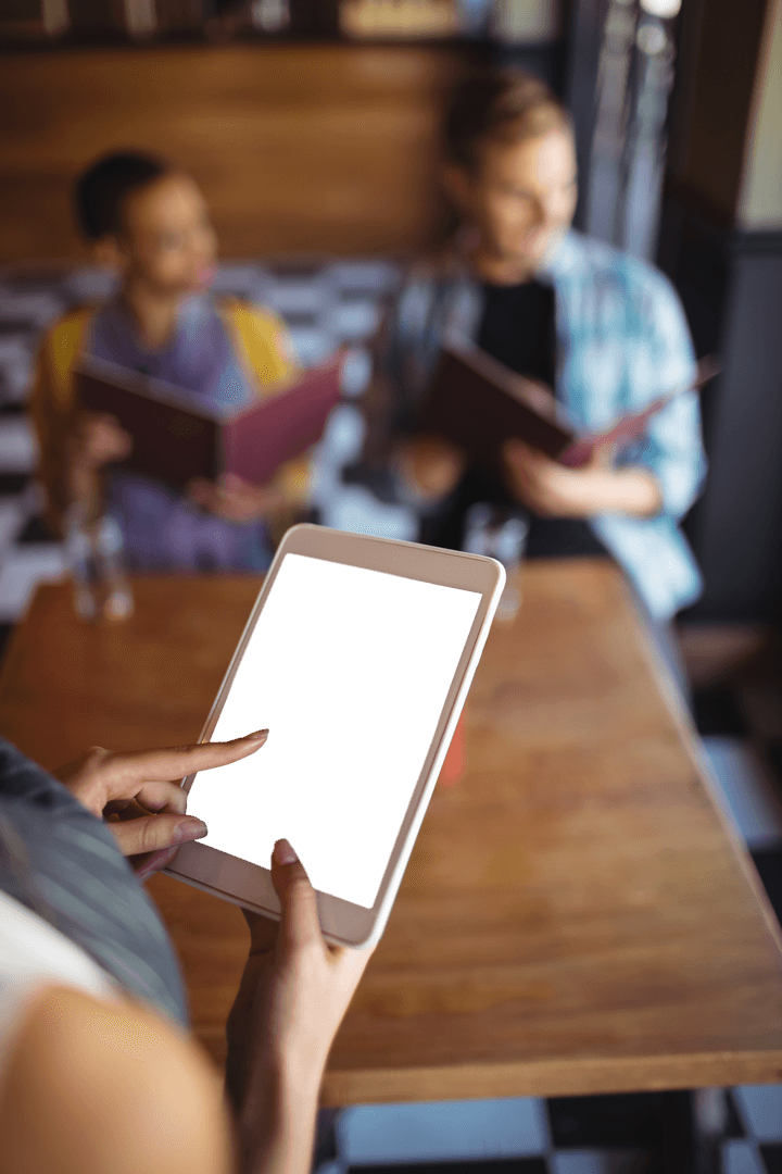 Transparent Touchscreen Tablet In Restaurant Scene with Diners