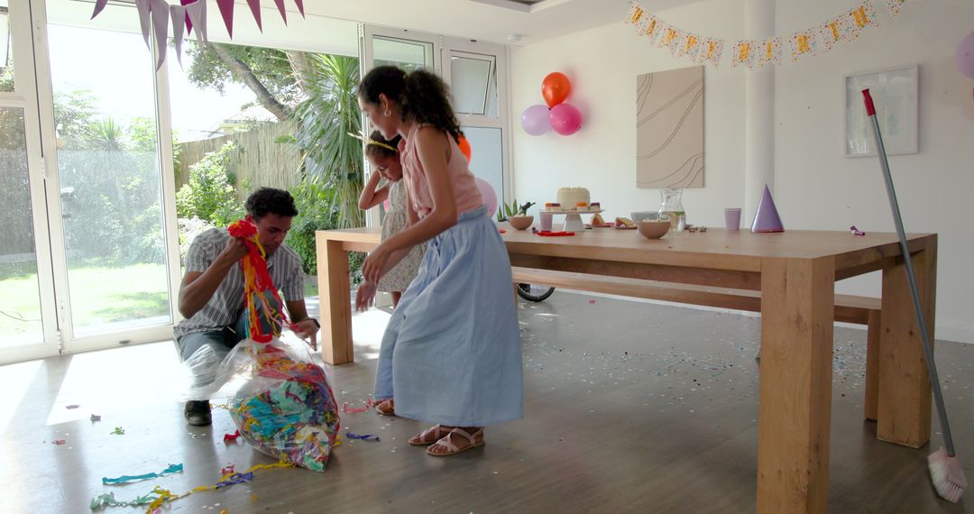 Family Engaged in Post-Party Cleanup at Home