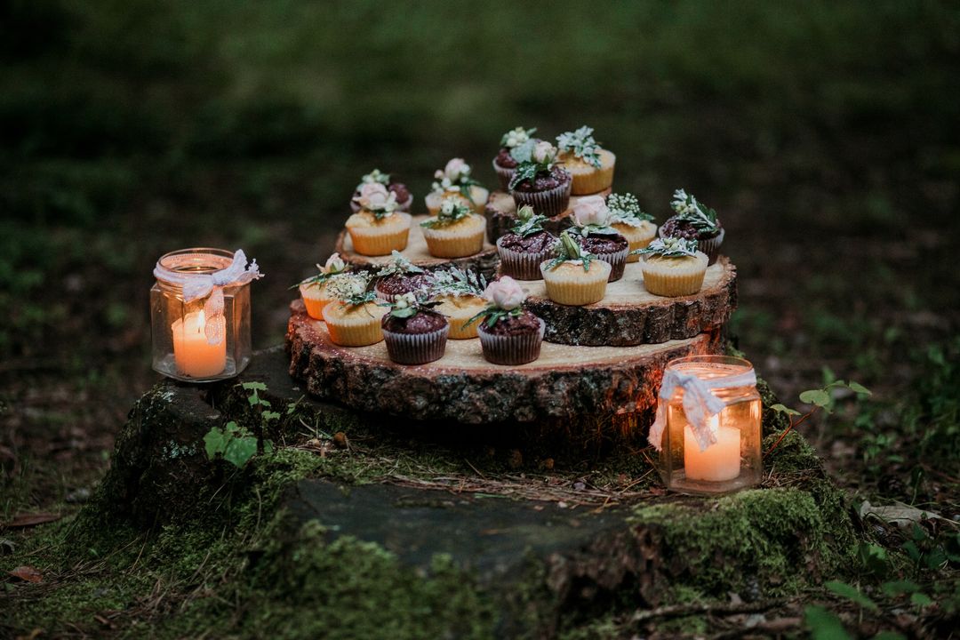 Rustic Outdoor Dessert Arrangement with Candles on Tree Stump