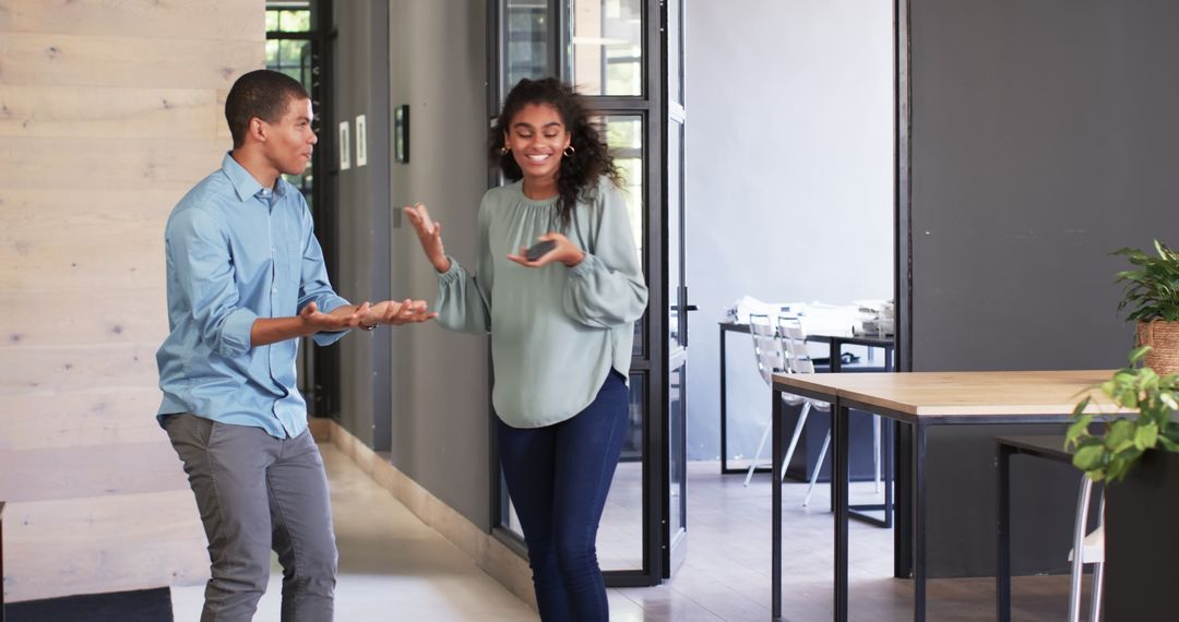 Multiracial Colleagues Discussing and Celebrating in Office Environment