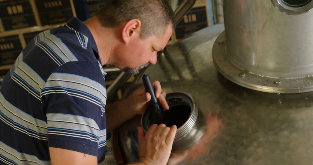 Man Inspecting Brewing Equipment in Brewery - Free Images, Stock Photos and Pictures on Pikwizard.com