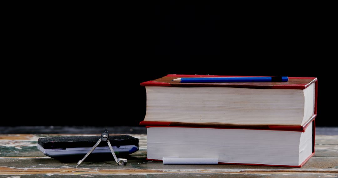 Two Stack of Books with Pencil and Broken Compass on Wooden Table - Free Images, Stock Photos and Pictures on Pikwizard.com