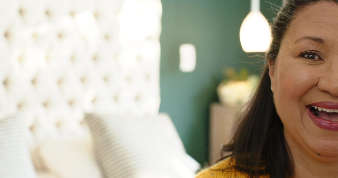 Smiling Woman Rejoicing in Cozy Bedroom with Soft Decor