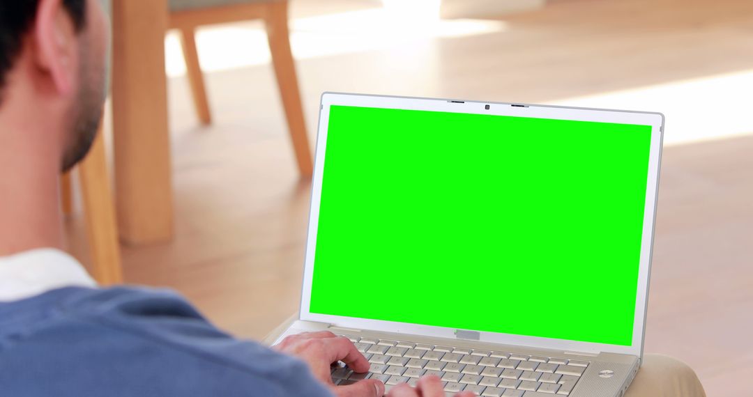 Person using laptop with green screen in home setting - Free Images, Stock Photos and Pictures on Pikwizard.com